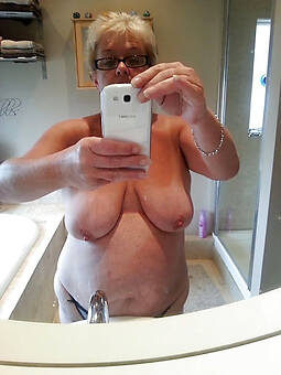 hot granny in glasses stripping